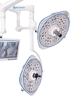 Two Skytron Aurora Four led surgical lights hanging from Skytron Booms with A Monitor arm