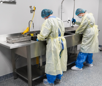 Skytron Processing Sinks in use by medical personnel in scrubs, angled to the right